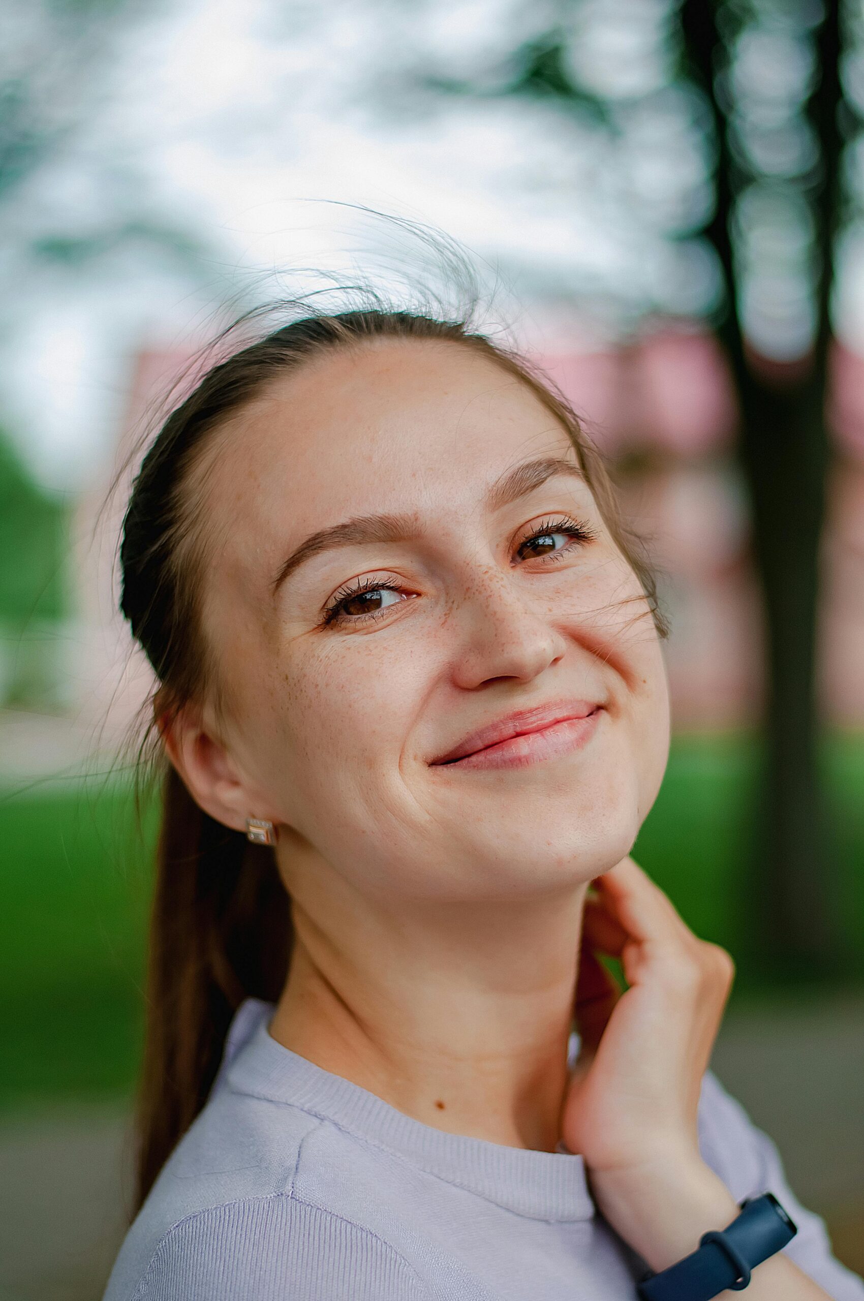 Portrait of a smiling woman enjoying a sunny day outdoors in Ukraine.